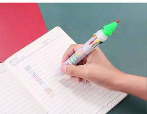 Detail of Christmas multi-color ballpoint pen with 3D silicone tree and writing samples
