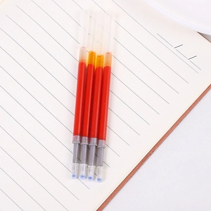 Close-up of four red 0.5mm gel ink refills with blue protective tips on a notebook