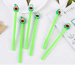 Close-up of cute avocado pens with unique emoji faces and bright green silicone toppers