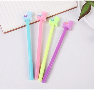 Set of four colorful cartoon alpaca gel pens arranged on a desk with notebooks