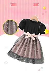Detail of girls' summer dress showing pink satin bow and black sequined mesh skirt fabric