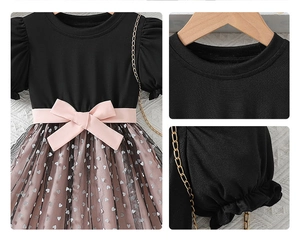 Close-up of pink mesh skirt with silver heart prints and a satin bow decoration