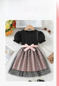 Flat lay detail of girl's dress with black puff sleeves and pink heart mesh skirt