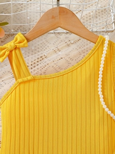 Girls summer yellow ribbed knit floral dress with shoulder bow detail on a wooden hanger