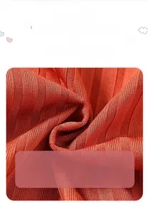 Close-up of breathable brick red ribbed cotton fabric for a girl's princess dress