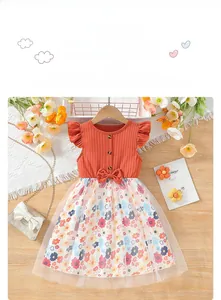 Detail of orange flutter sleeve bodice with mesh floral skirt and waist bow decoration