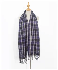 Dettaglio della sciarpa in maglia a quadri viola e neri con eleganti frange morbide