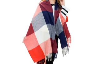 Detail of red and navy plaid scarf with long tassels and thick woolen texture