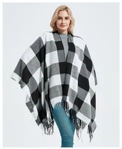 Detail of classic black and white buffalo check pattern on stylish fringed shawl
