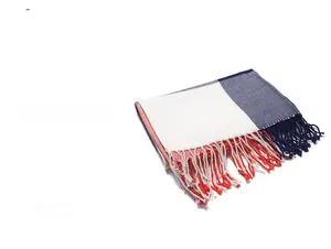 Detail of knit fringe scarf in cream, navy blue, and terracotta red with soft texture