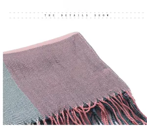 Close-up of pink and grey plaid scarf with twill weaving and tassel detail decoration
