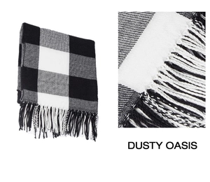 Detail shot of black and white buffalo check knit scarf with delicate fringe edges