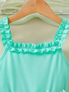 Mint green ribbed toddler dress with delicate ruffle shoulder straps on a hanger