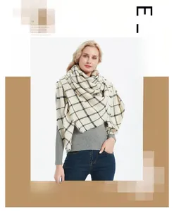 Detail of elegant black and beige plaid scarf with soft cashmere-like texture and frayed edges