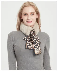 Close-up of leopard print ribbon on plush faux rabbit fur scarf for women
