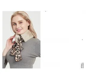 Close-up of beige faux fur scarf with leopard print satin ribbon tied in a bow