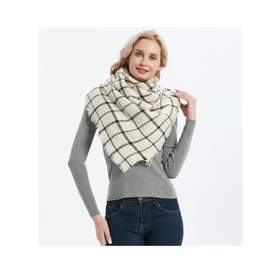 Detail of soft beige plaid scarf with black grid pattern and fine fringed edges