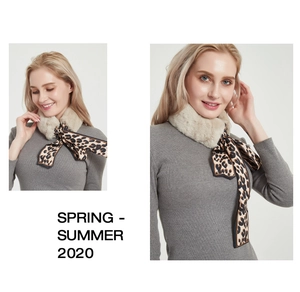 Detail of faux rabbit fur collar with leopard print silk ribbon bow for winter