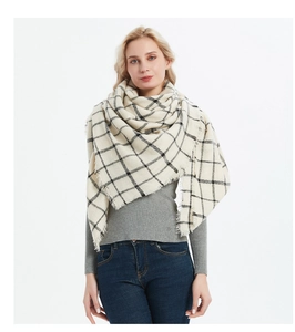 Close-up of beige plaid shawl with black windowpane pattern and delicate fringe edges