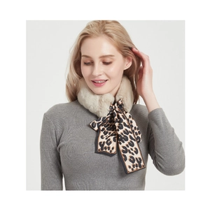 Close-up of fluffy faux rabbit fur neck warmer with a leopard print silk bow detail