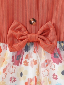 Girls orange ribbed knit dress with large waist bow and floral mesh tulle skirt overlay