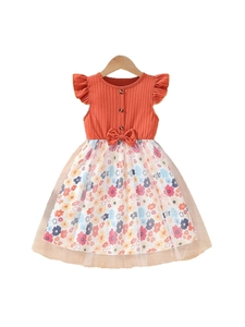 Girls orange ribbed knit dress with floral mesh skirt and bow detail on a hanger