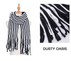 Detail view showing black and white striped knit scarf with decorative fringe texture