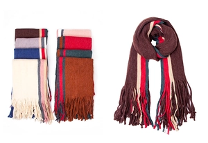 Close-up of colorful striped knitted scarves with long fringe tassels in various colors