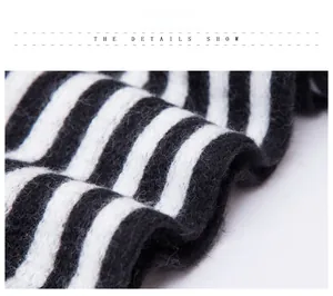 Close-up of black and white striped knitted scarf with soft mohair texture details