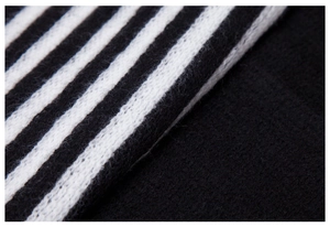 Close-up macro view of black and white striped knit fabric texture on a warm scarf