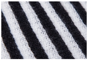 Macro shot of soft black and white striped knit fabric texture with fluffy finish