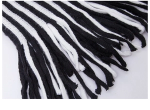 Detailed macro shot of classic black and white striped knit scarf with long fringe tassels