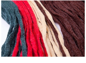 Close-up of multicolored knit fibers showing warm red and green yarn texture details
