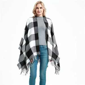 Women's black and white plaid knit poncho shawl with fringe details for autumn and winter