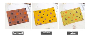 Detail of soft knit scarves with polka dot patterns in caramel yellow and green colors