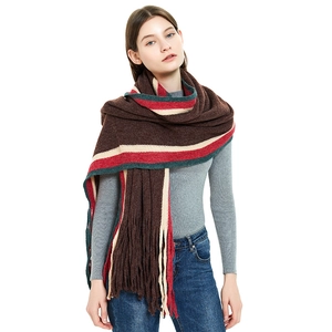 Chic autumn knit scarf with colorful stripes and long tassels on dark brown base