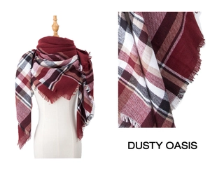 Detail of burgundy plaid scarf with fringed edges and soft woven texture for autumn