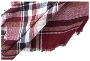 Detailed view of burgundy plaid scarf featuring soft fringe edges and woven fabric texture