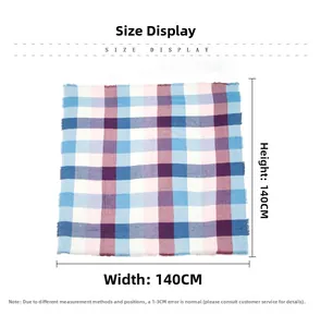 Detail showing the 140x140cm dimensions of a plaid square scarf with tassel edges