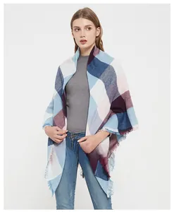 Close-up of pastel plaid scarf detail with soft sky blue and pink tassel edges