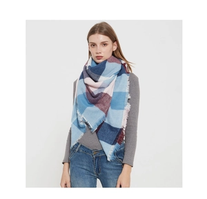 Detail of checkered winter scarf featuring plaid pattern and soft tassel edges
