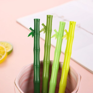 Set of 4 creative green bamboo-shaped pens in a pink marble cup with decorative leaves