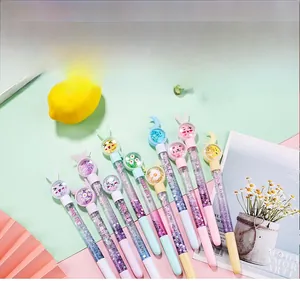 Macro detail of macaron liquid sand pens featuring assorted cartoon topper charms