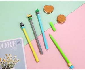 Close-up of four colorful cactus pens with soft cartoon toppers on a pastel background