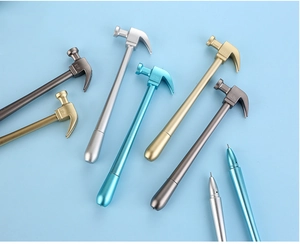 Close-up of creative hammer-shaped pens in metallic silver, gold, and bronze finishes