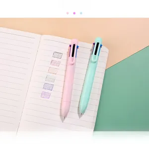 Detail of multi-color retractable ballpoint pen in pastel pink and soft green casing