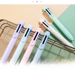 Detail of macaron-colored multi-ink ballpoint pens in a decorative wire basket