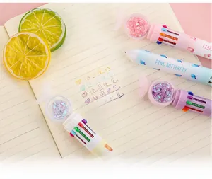 Detail of multi-color retractable ballpoint pen with pink butterfly and sequin heart globe