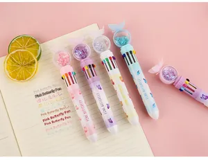 Detail of multi-color retractable ballpoint pen with sequin butterfly topper and pink design