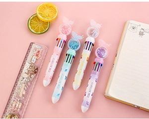 Detail of ten-color ballpoint pens with butterfly sequins and a liquid glitter ruler